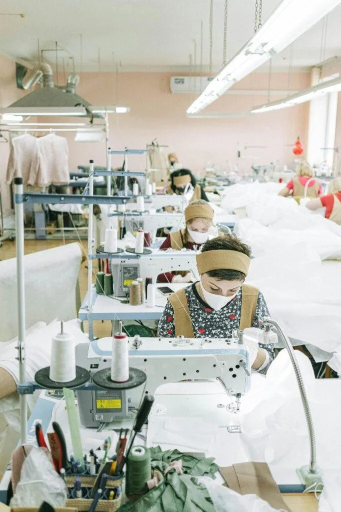 Garment workers at sewing machines in a factory