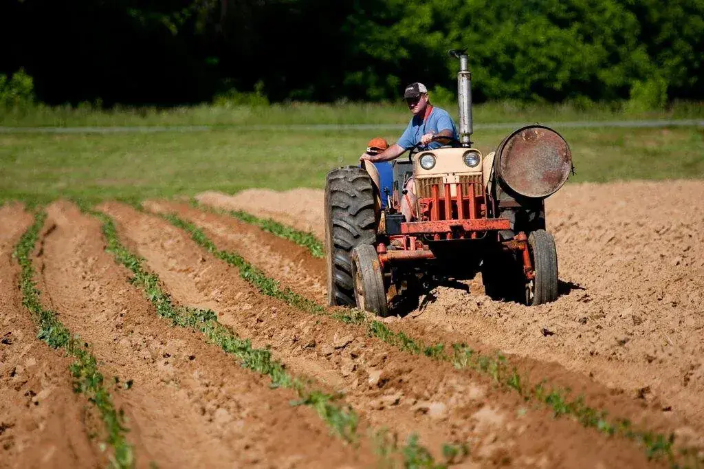 Farmer driving a tractor across a field