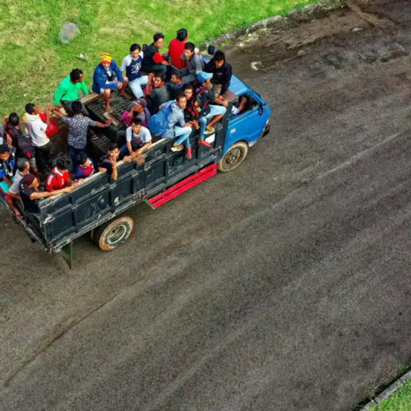 Workers packed on a truck bed