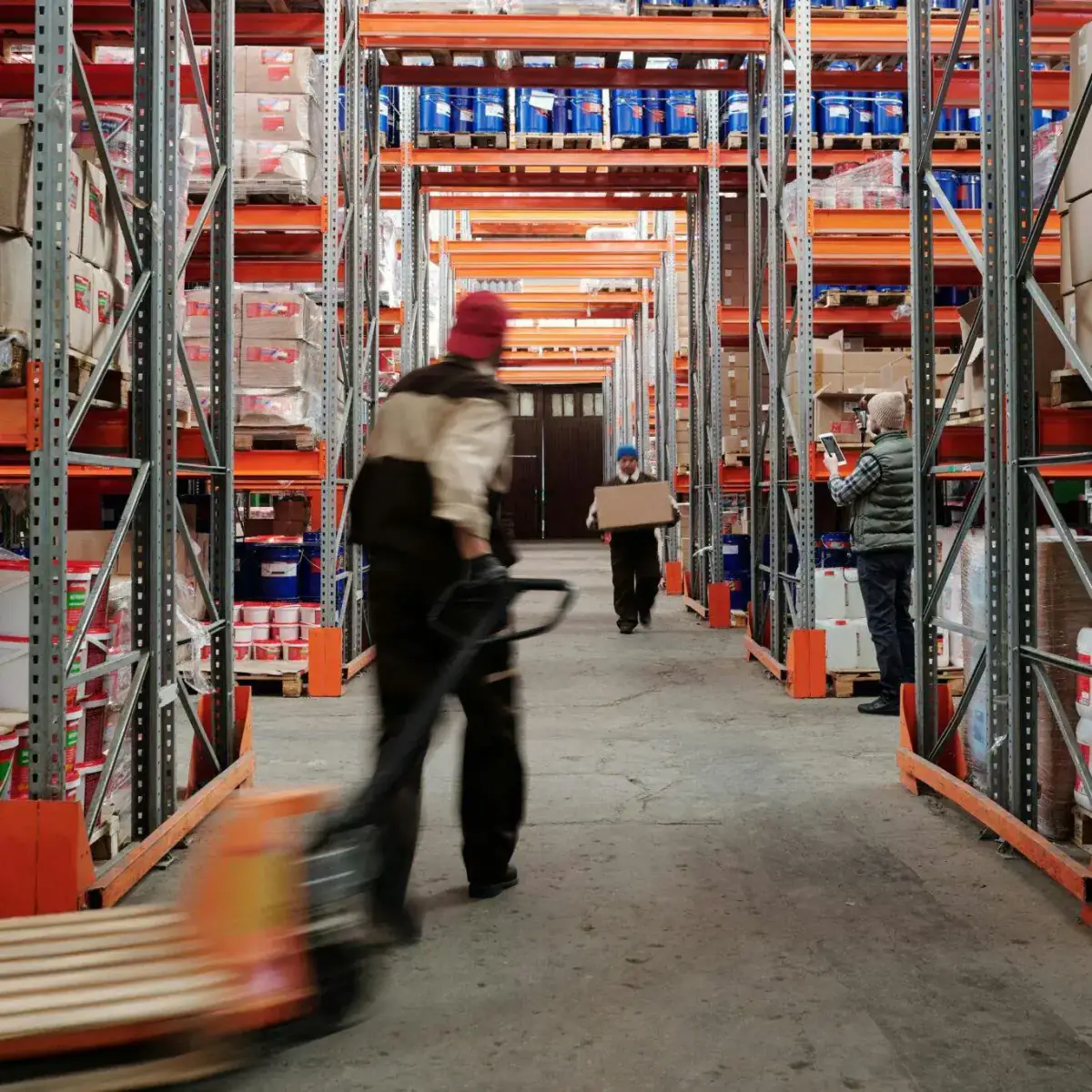 Workers moving goods in a warehouse